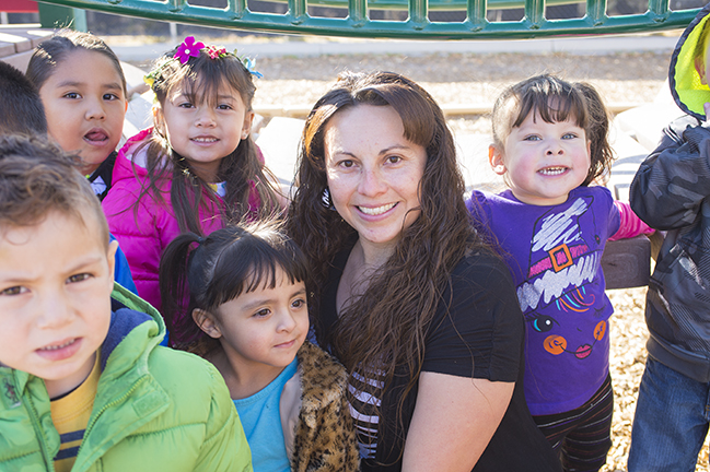 Teacher with several students smiling