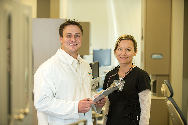 Doctor and Nurse Standing with Clip Board